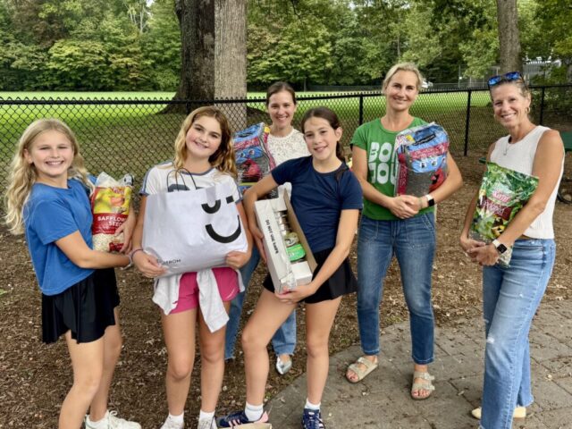 NCL girls and Moms displaying bird seed purchased for Bristow (1)
